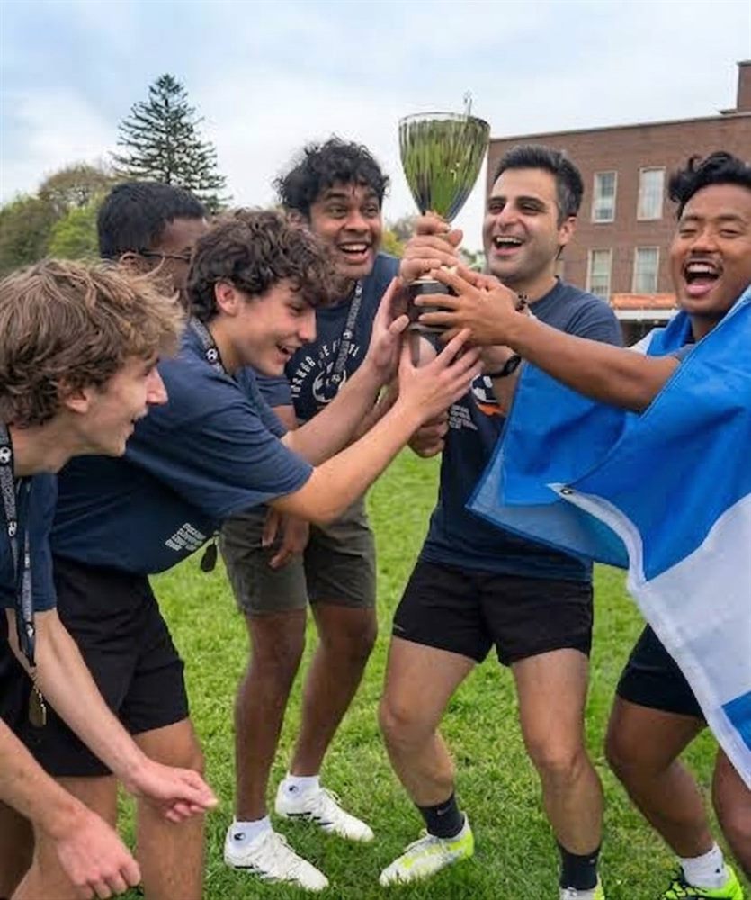 Alireza Khodayarkhani lifting a trophy with his soccer team